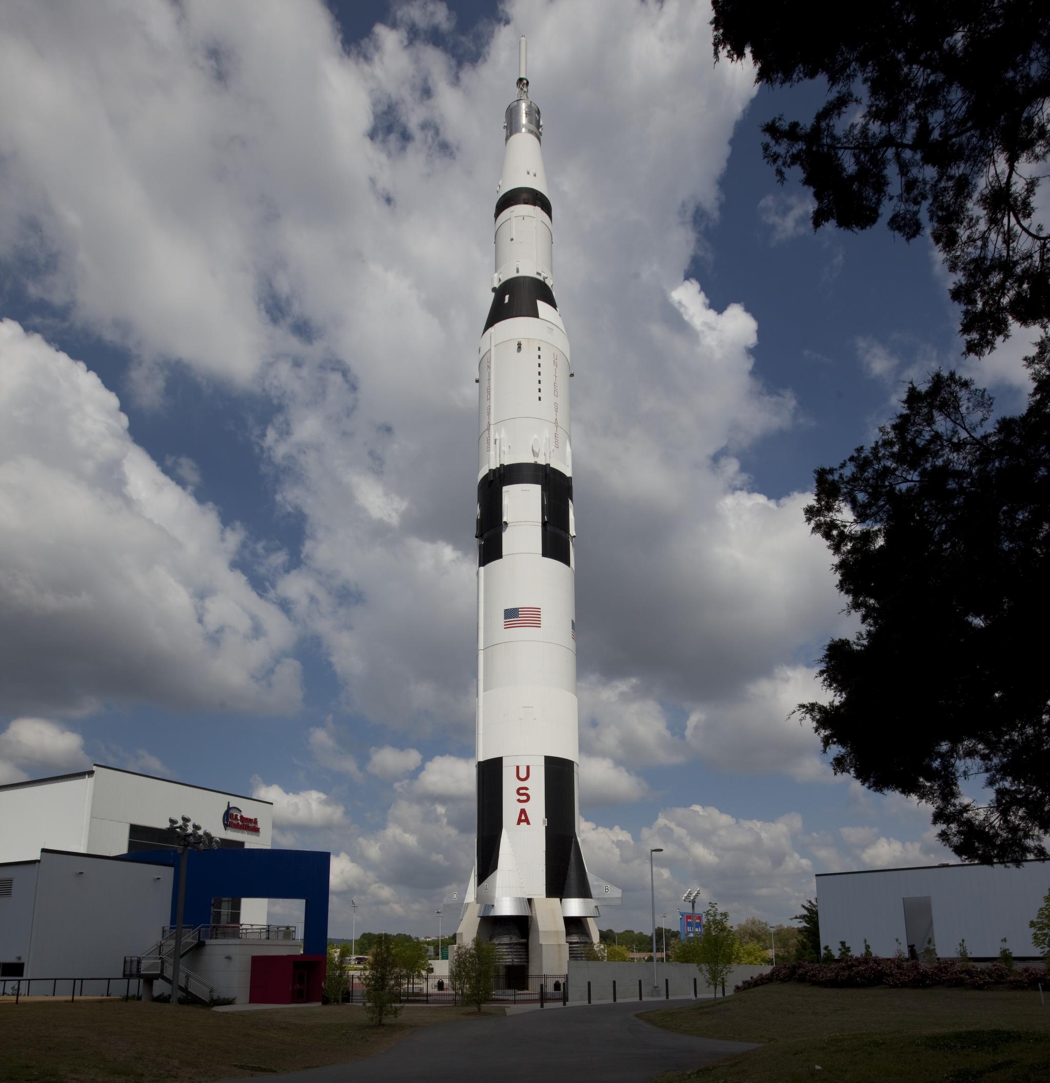 A Saturn V rocket reaching into a cloud-filled sky